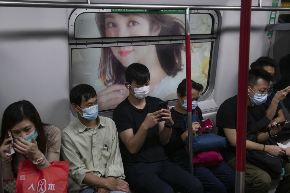 HONG KONG, CHINA - 2020/03/31: Commuters inside a tram wearing protective masks as a preventive measure against the spread of Coronavirus. Bars, Mah Jong clubs, gaming centers and parks have been closed for the next 14 days as well as avoid gatherings of more than 4 people. Hong Kong has so far reported 714 confirmed infected cases, and from those, 566 have been in the past 14 days. (Photo by Miguel Candela/SOPA Images/LightRocket via Getty Images)