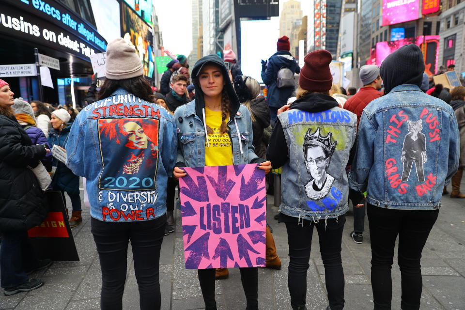 Several young women show off their politically motivated denim jackets in Time Square after participating in the Women’s March in New York City on Jan. 19, 2019 in New York City. (Photo: Gordon Donovan/Yahoo News)