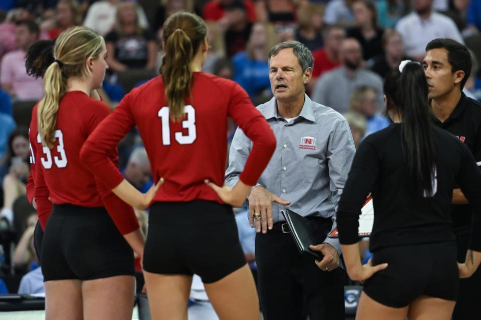 Nebraska volleyball head coach John Cook (center) coaches his players.