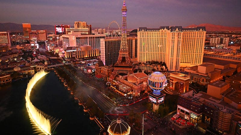 A photo of the Las Vegas Strip with F1 cars driving on it. 