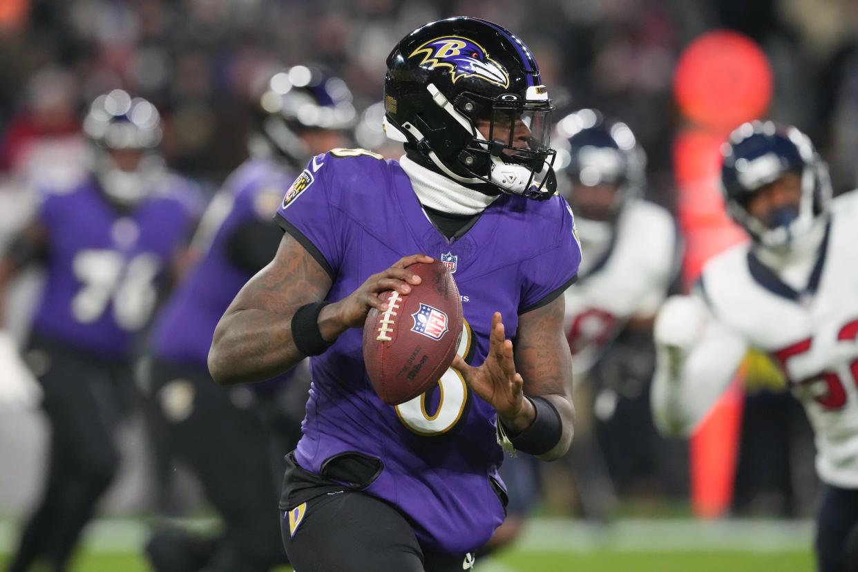 Lamar Jackson rolls out to throw during the Baltimore Ravens' AFC divisional playoff win against the Houston Texans at M&T Bank Stadium on Jan. 20, 2024.