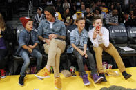 British soccer player David Beckham (2nd L) sits courtside with his sons Cruz (L), Romeo (2nd R) and Brooklyn (R) before the NBA basketball game between the Los Angeles Lakers and Phoenix Suns in Los Angeles November 16, 2012. REUTERS/Danny Moloshok (UNITED STATES - Tags: SPORT BASKETBALL ENTERTAINMENT SOCCER)