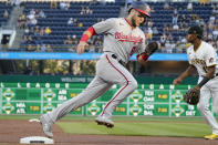 Washington Nationals' Carter Kieboom dashes around third and Pittsburgh Pirates third baseman Ke'Bryan Hayes on his way to score on a triple by Riley Adams during the second inning of a baseball game Friday, Sept. 10, 2021, in Pittsburgh. (AP Photo/Keith Srakocic)