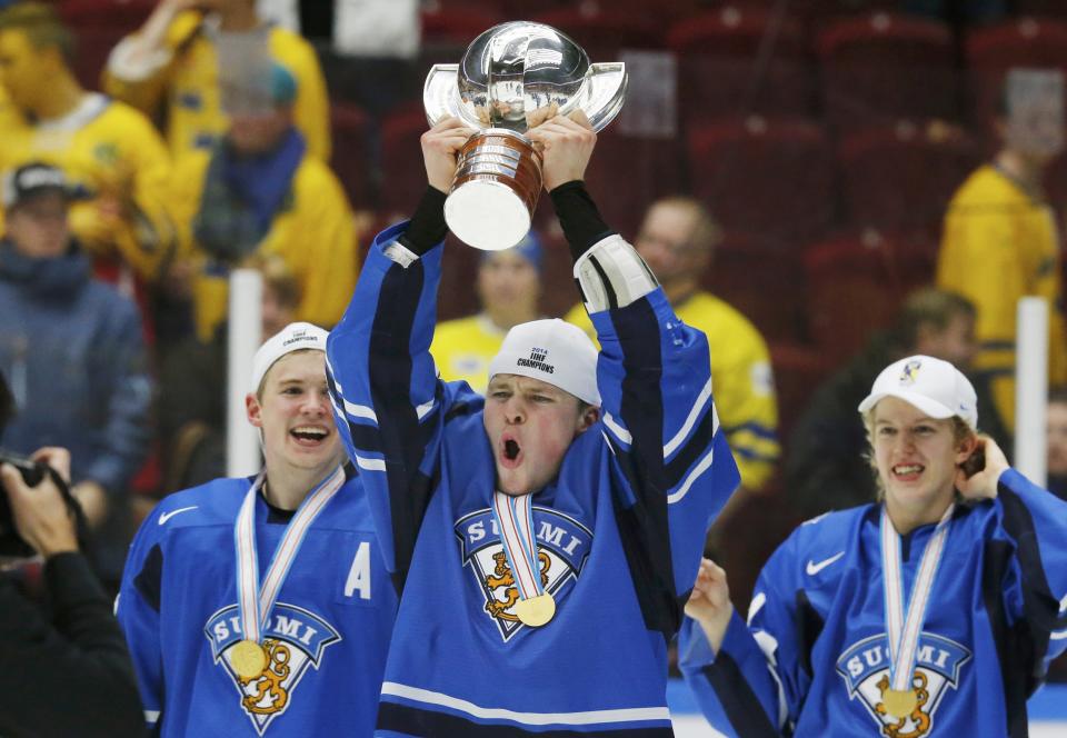 Finland's Mikko Lehtonen celebrates with the trophy after his team defeated Sweden in overtime of their IIHF World Junior Championship gold medal ice hockey game in Malmo, Sweden, January 5, 2014. REUTERS/Alexander Demianchuk (SWEDEN - Tags: SPORT ICE HOCKEY)