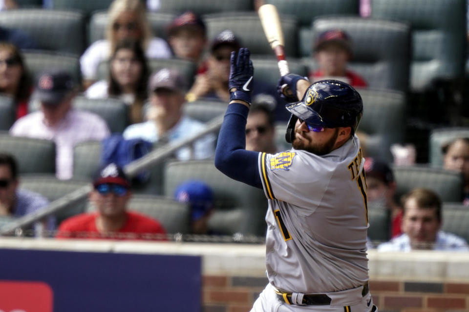 Milwaukee Brewers' Rowdy Tellez (11) strikes out against Atlanta Braves starting pitcher Ian Anderson during the fourth inning of Game 3 of a baseball National League Division Series, Monday, Oct. 11, 2021, in Atlanta. (AP Photo/Brynn Anderson)