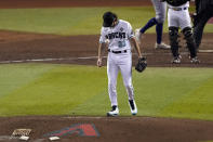 Arizona Diamondbacks starting pitcher Zac Gallen (23) tosses the baseaball after giving up an RBI single during the seventh inning in Game 5 of the baseball World Series against the Texas Rangers Wednesday, Nov. 1, 2023, in Phoenix. (AP Photo/Ross D. Franklin)