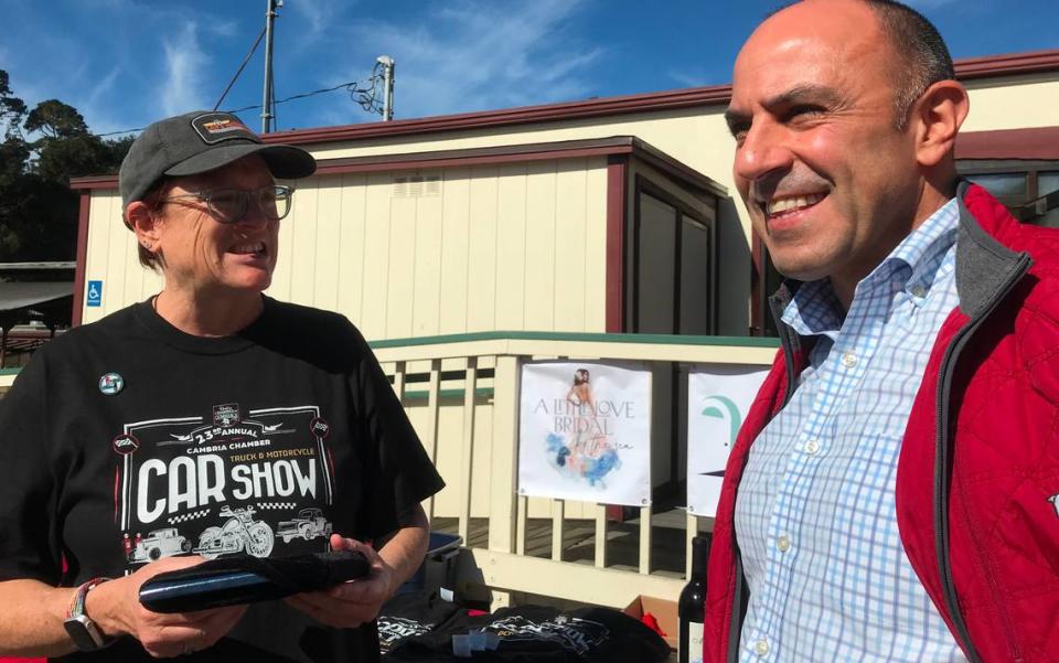 U.S. Rep. Jimmy Panetta, left, is greeted at the Cambria Chamber of Commerce’s 23rd annual car show on Saturday, Oct. 21, 2023, by the chamber’s Executive Director Lorienne Schwenk. The congressman, who had flown back to California from Washington D.C. earlier that morning, spoke briefly to attendees before heading to another function in Paso Robles.