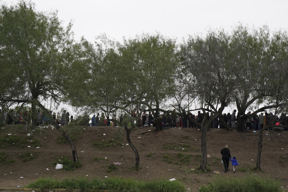 Haitian migrants who hope to apply for asylum in the U.S. wait to register their names on a list made by a religious organization in Reynosa, Mexico, Wednesday, Dec. 21, 2022, on the other side of the border with McAllen, Texas. (AP Photo/Fernando Llano)