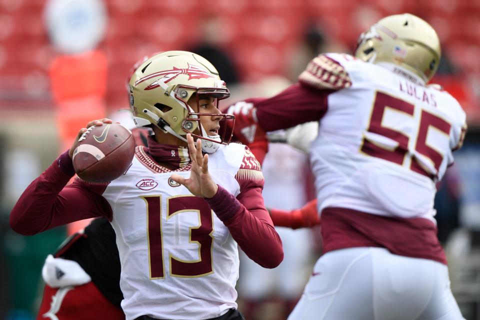 Oct 24, 2020; Louisville, Kentucky, USA;  Florida State Seminoles quarterback Jordan Travis (13) looks to pass against the Louisville Cardinals during the first half of play at Cardinal Stadium. Jamie Rhodes-ACC Pool