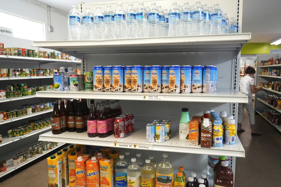 A client select items at the House of Hope food pantry, Tuesday, May 21, 2024, in Stuart, Fla. The Community Foundation of Martin - St. Lucie counties has overhauled its approach to disaster response by creating a permanent fund and establishing preemptive agreements with nonprofit partners like House of Hope to deploy funds to them immediately when a storm is forecasted. (AP Photo/Marta Lavandier)