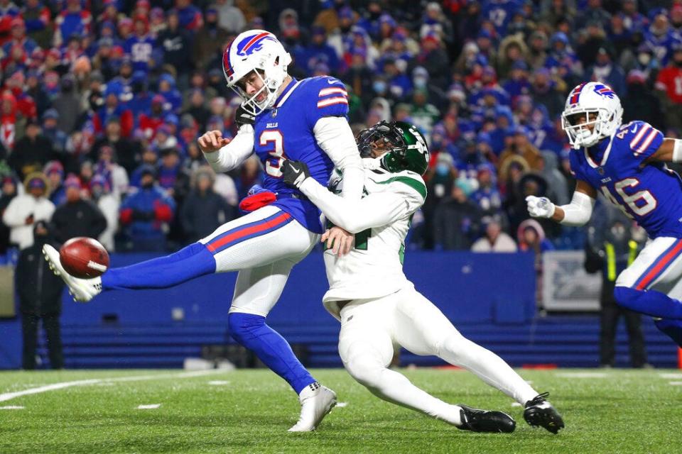 Matt Haack is tackled while attempting to punt for the Bills by Justin Hardee of the Jets, Sunday, Jan. 9, 2022.
