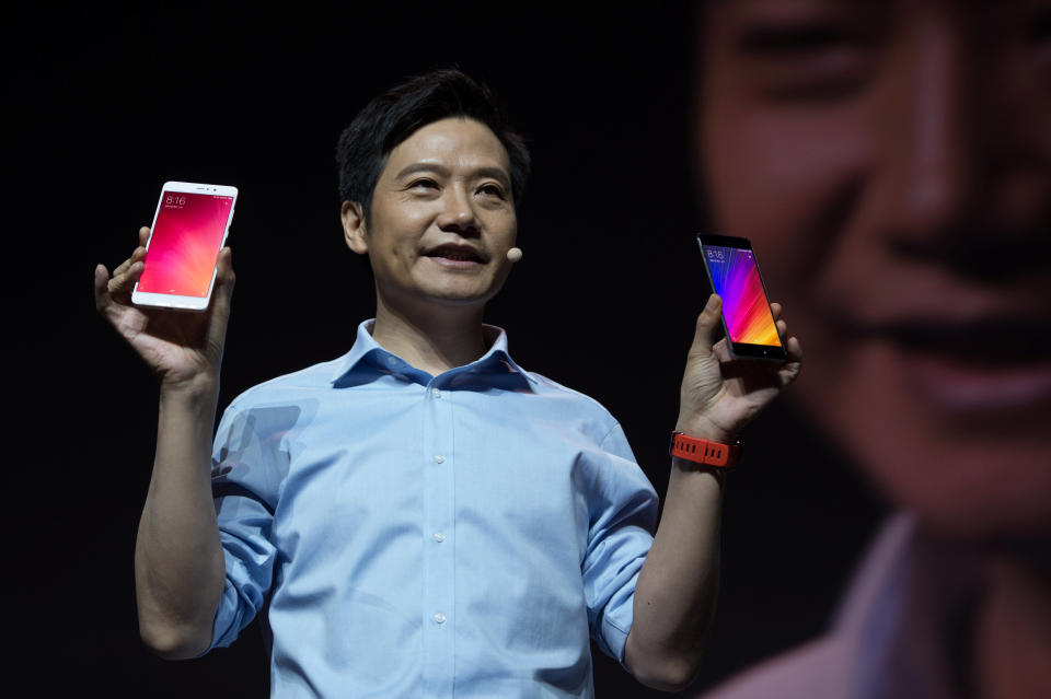 Lei Jun, founder and CEO of Xiaomi, holds Xiaomi 5s and 5s plus phones. [REUTERS/Stringer]