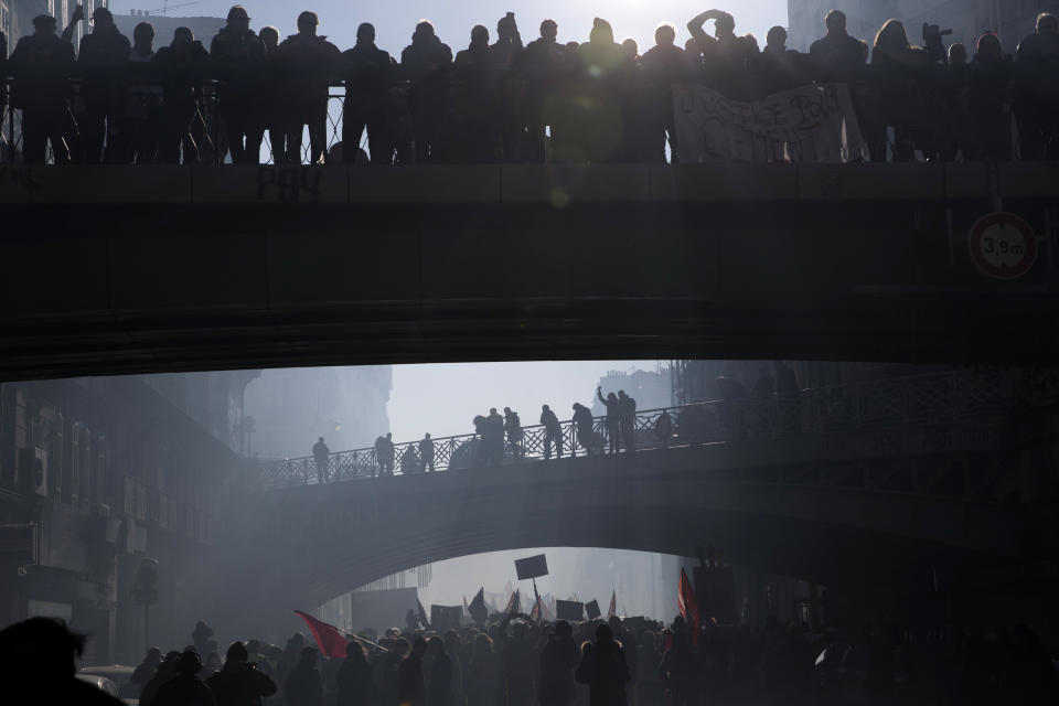 Protesters march during a mass strike in Marseille, southern France, Tuesday, Dec. 10, 2019. French airport employees, teachers and other workers joined nationwide strikes Tuesday as unions cranked up pressure on the government to scrap upcoming changes to the country's national retirement system. (AP Photo/Daniel Cole)