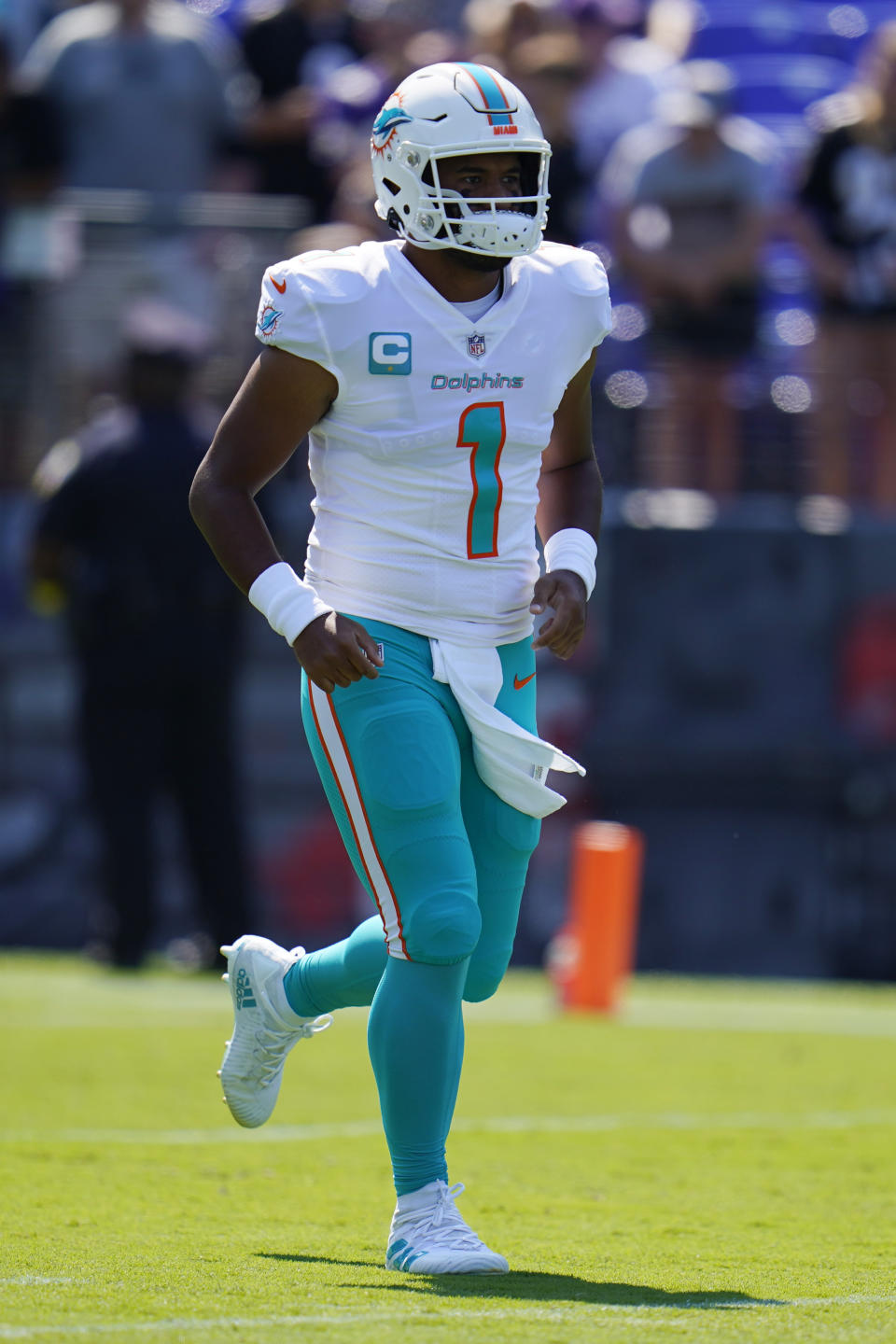 Miami Dolphins quarterback Tua Tagovailoa (1) runs on the field before an NFL football game against the Baltimore Ravens, Sunday, Sept. 18, 2022, in Baltimore. (AP Photo/Julio Cortez)