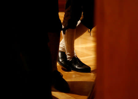 A man dressed in Tracht (traditional costume) stands at the bar during the traditional Kathreintanz in Vienna, Austria, November 26, 2016. Picture taken November 26, 2016. REUTERS/Leonhard Foeger