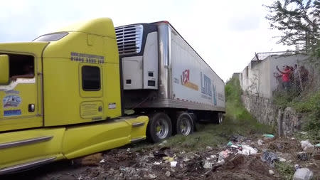 A truck leaves with an abandoned trailer full of bodies that has been parked in Tlajomulco de Zuniga, Jalisco, Mexico September 15, 2018 in this still image taken from a video obtained September 17, 2018. REUTERS TV/via REUTERS