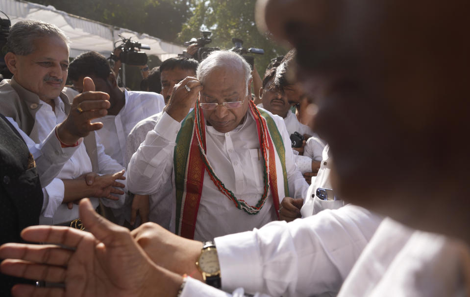 Newly elected president of India’s main opposition Congress party Mallikarjun Kharge, center, stands amid his supporters after the election results, in New Delhi, India, Wednesday, Oct. 19, 2022. Kharge was elected new president in a contest in which the Nehru-Gandhi family, which has led the party for more than two decades, did not compete. (AP Photo/Manish Swarup)