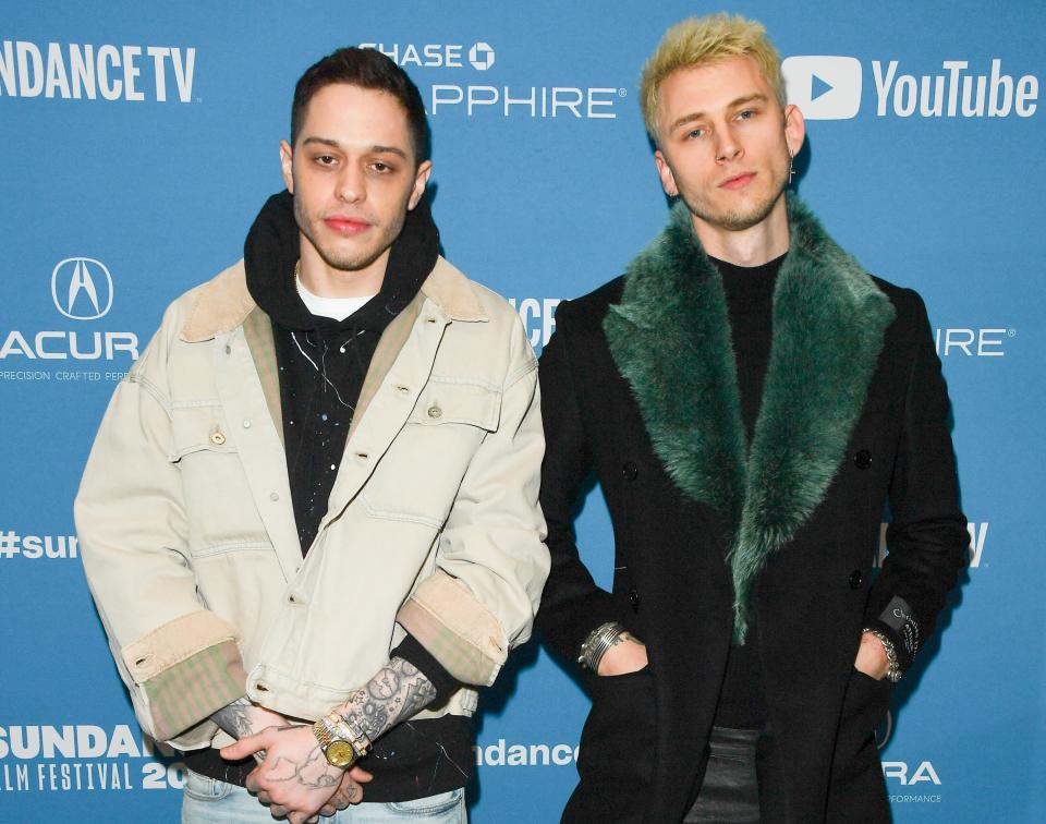 Pete and MGK pulling matching elbows-out poses on the red carpet