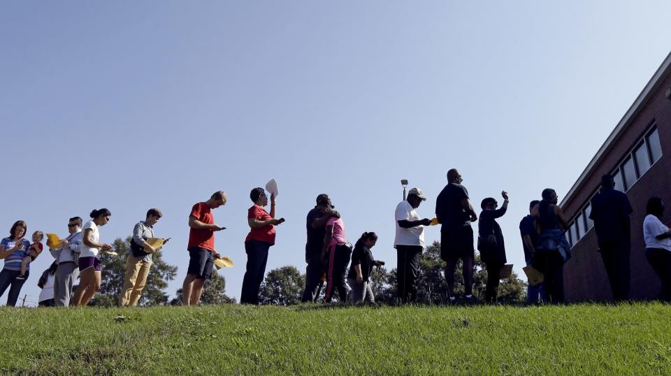 People line up under the morning sun for early voting at Chavis Community Center in Raleigh, N.C., Thursday, Oct. 20, 2016. (Photo: Gerry Broome/AP)