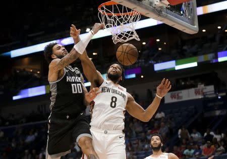 Mar 28, 2019; New Orleans, LA, USA; Sacramento Kings center Willie Cauley-Stein (00) dunks over New Orleans Pelicans center Jahlil Okafor (8) during the second quarter at the Smoothie King Center. Mandatory Credit: Derick E. Hingle-USA TODAY Sports