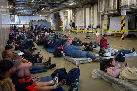 Evacuees formerly stranded in the earthquake-affected town of Kaikoura rest aboard the New Zealand naval ship HMNZS Canterbury. CPL Amanda McErlich/Courtesy of Royal New Zealand Defence Force/Handout via REUTERS