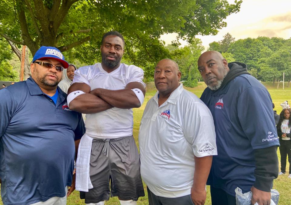 Several former Poughkeepsie youth coaches were honored during the alumni football game on June 18, 2022. From left: Nakia Wood, event organizer Shonda Faulkner, Arthur Turner and Norman Moore.