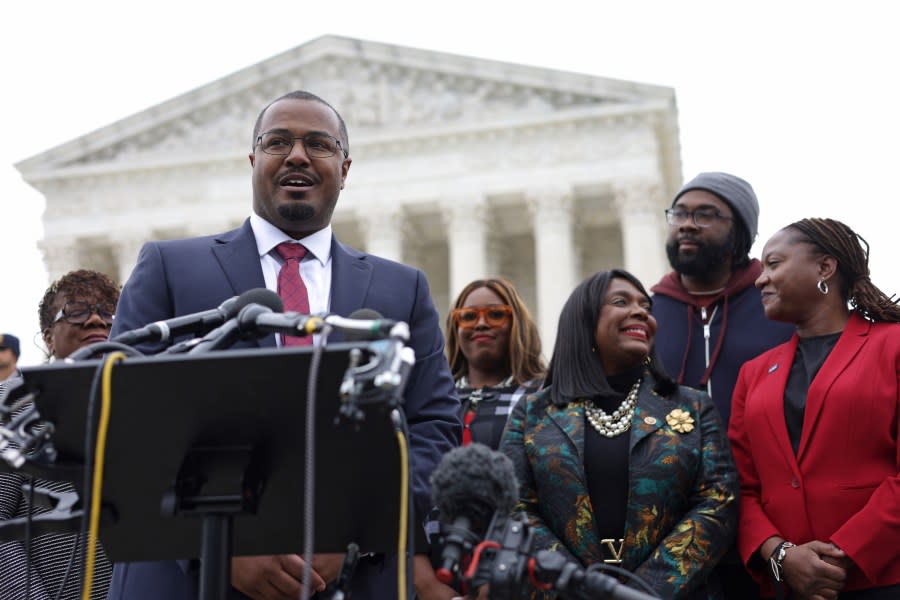 Alabama must undergo redistricting after court challenges. Above, Deuel Ross of the NAACP Legal Defense Fund addresses the state’s voting rights case outside the Supreme Court in October 2022. Ross, lead counsel for the plaintiffs, was joined by LDF president and director-counsel Janai Nelson (right), plaintiff Evan Milligan (second from right), Rep. Terri Sewell (third from right) and others. (Photo by Alex Wong/Getty Images)