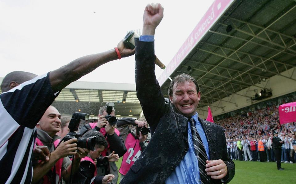 Kevin Campbell pours champagne over Bryan Robson of West Brom after securing premiership status at the end of the Barclays Premiership match between West Bromwich Albion and Portsmouth at The Hawthorns on May 15, 2005 in Birmingham - Getty Images/Laurence Griffiths