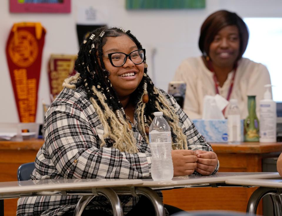 Central Falls High School 12th-grader Alexis Ambers participates in the Law and Literature class last fall. In the background is her English teacher, Deloris Grant.