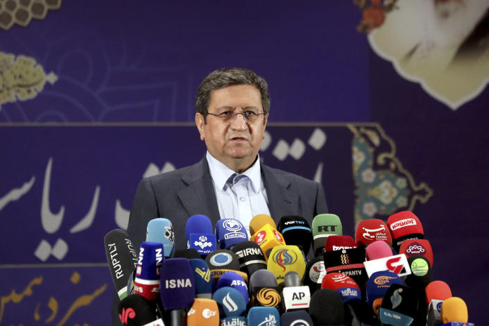 Head of the central bank of Iran Abdolnasser Hemmati speaks with journalists after registering his candidacy for the upcoming presidential elections at the Interior Ministry in Tehran, Iran, Saturday, May 15, 2021. Iran named seven candidates Tuesday, May 15, for its June 18 presidential election, approving the candidacy of Hemmati and the hard-line cleric running its judiciary, Ebrahim Raisi, while barring prominent candidates allied to its current president amid tensions with the West over its tattered nuclear deal. (AP Photo/Ebrahim Noroozi)