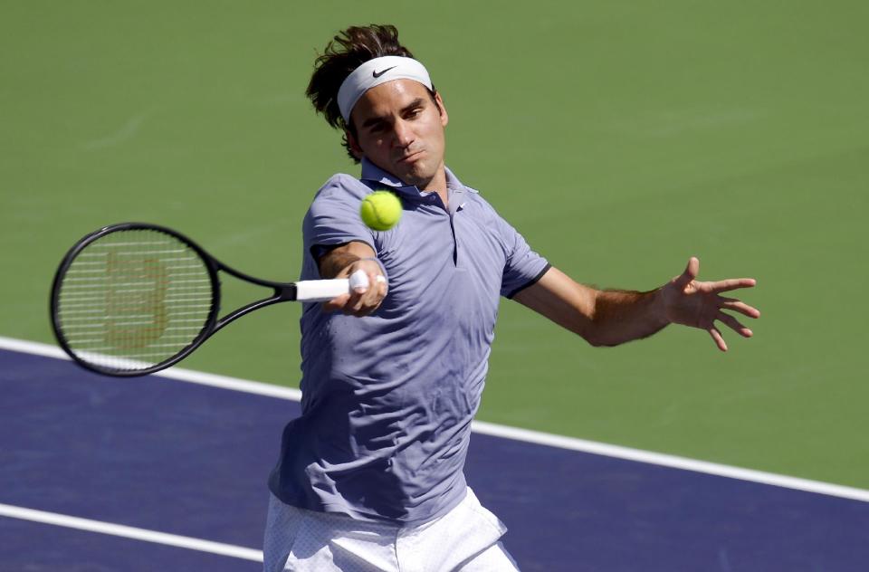 Roger Federer, of Switzerland, returns a shot to Alexandr Dolgopolov, of Ukraine, during their semifinal match at the BNP Paribas Open tennis tournament, Saturday, March 15, 2014, in Indian Wells, Calif. (AP Photo/Mark J. Terrill)