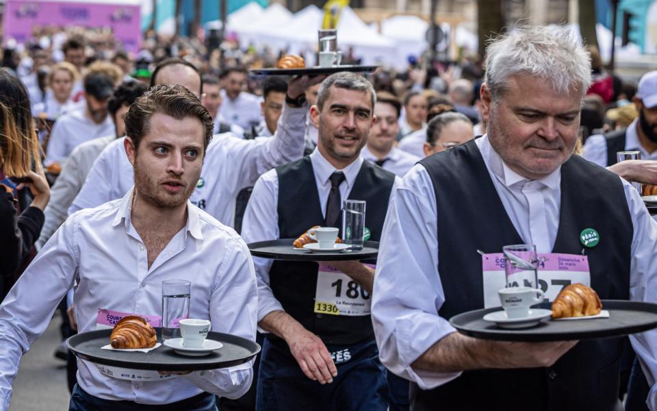 Waiters hold their trays as they rush through the capital over a course of 1.25 miles