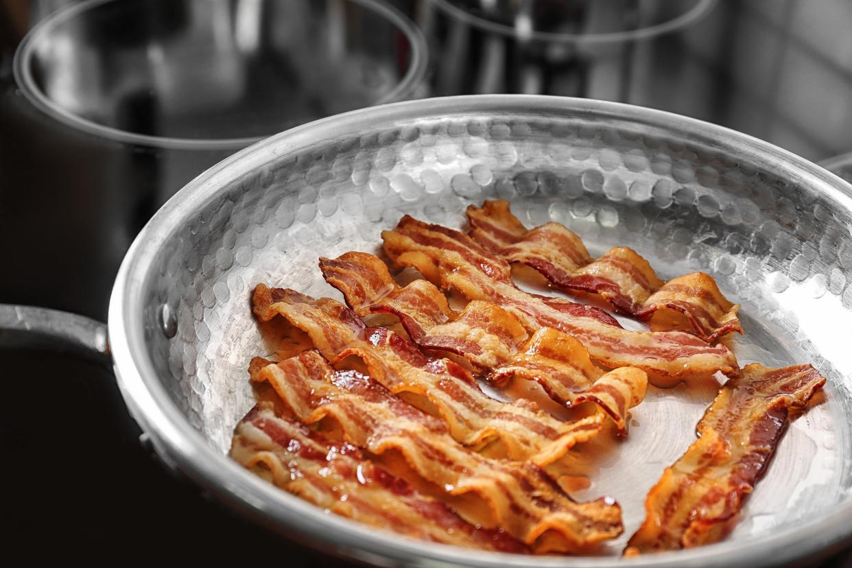 pan with strips of fried bacon on stove