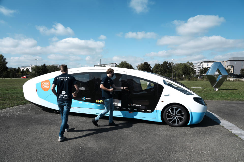 The solar-powered vehicle is on display on a closed road, in Guyancourt, south of Paris, Friday Sept. 24, 2021. A group of Dutch students has reimagined van life and is hitting the road to Portugal. Just don't call their groundbreaking new solar-powered vehicle a campervan. (AP Photo/Thibault Camus)