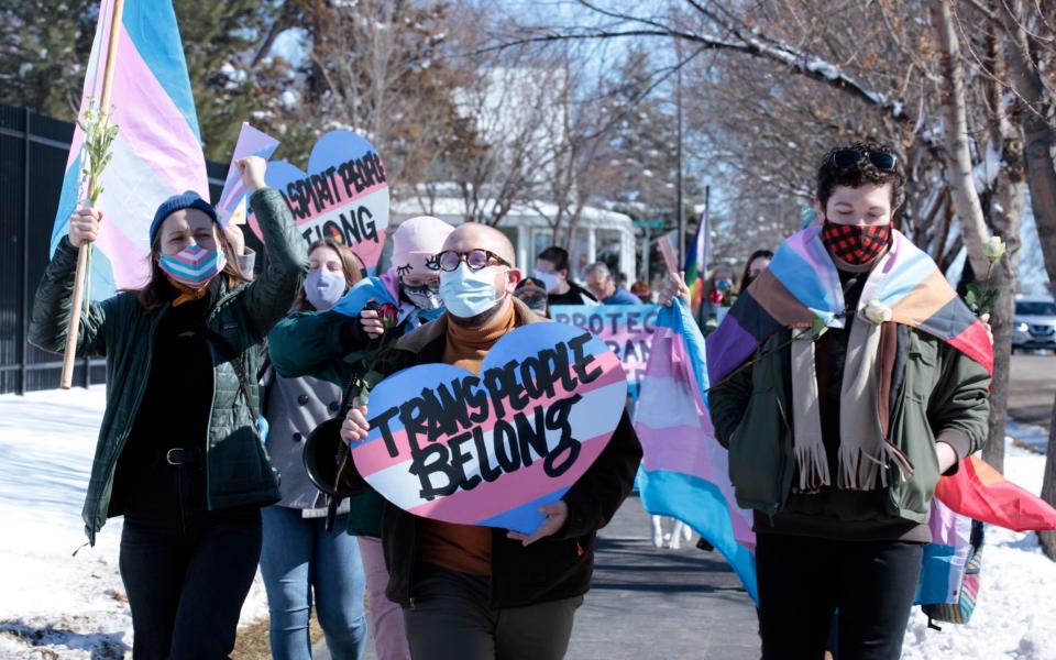 Advocates for transgender people march from the South Dakota governor's mansion to the Capitol in Pierre - AP