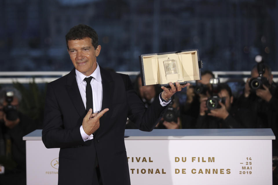 Actor Antonio Banderas poses with the best actor Palme d'Or award for the film 'Pain and Glory' during a photo call following the awards ceremony at the 72nd international film festival, Cannes, southern France, Saturday, May 25, 2019. (AP Photo/Petros Giannakouris)
