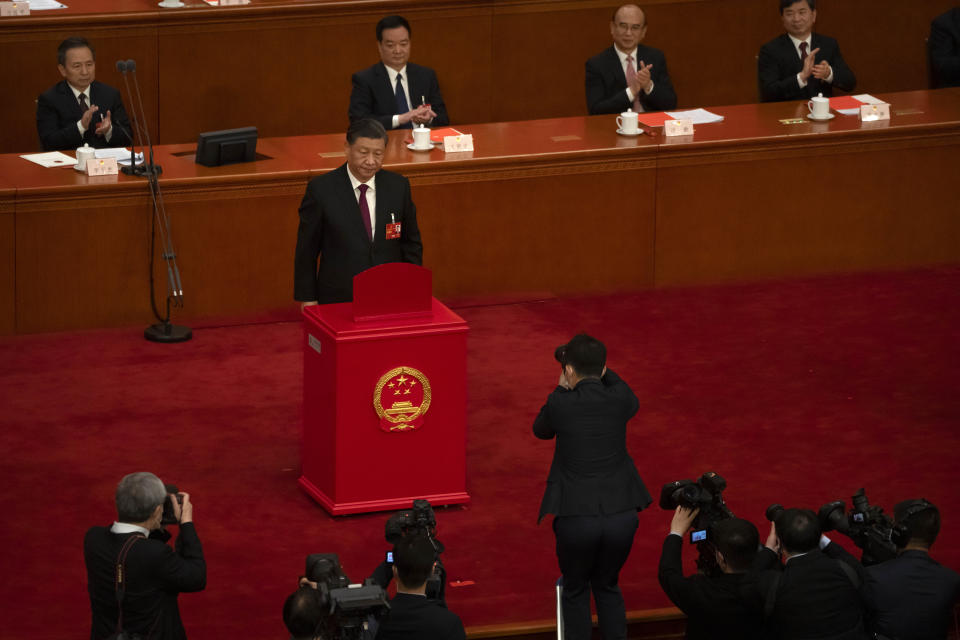 Chinese President Xi Jinping casts his vote during a session of China's National People's Congress (NPC) at the Great Hall of the People in Beijing, Friday, March 10, 2023. Chinese leader Xi Jinping was awarded a third five-year term as president Friday, putting him on track to stay in power for life at a time of severe economic challenges and rising tensions with the U.S. and others. (AP Photo/Mark Schiefelbein)