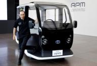 An employee of Toyota Motor Corp. demonstrates APM, a mobility vehicle designed expressly for use at the Tokyo 2020 Olympic and Paralympic Games, during a press preview in Tokyo