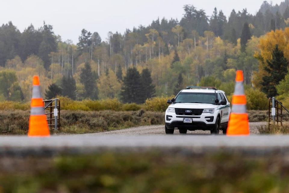 <div class="inline-image__caption"><p>A park ranger at a roadblock at the entrance of Spread Creek Campground on Sept. 19 near Moran, Wyoming.</p></div> <div class="inline-image__credit">Natalie Behring/Getty</div>