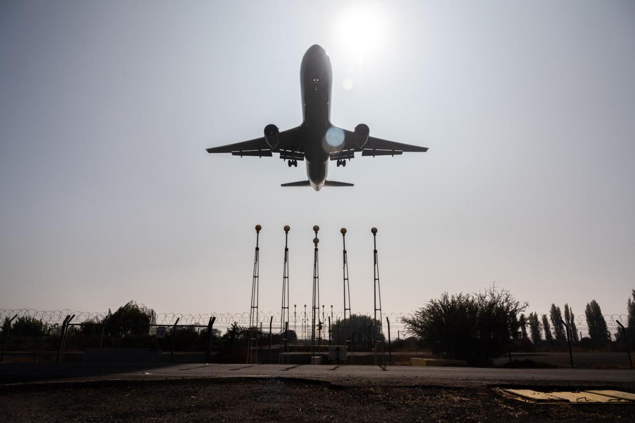 An aircraft lands at Arturo Merino Benitez International Airport (SCL) in Santiago, Chile, on Friday, May 5, 2023.Photographer: Cristobal Olivares/Bloomberg