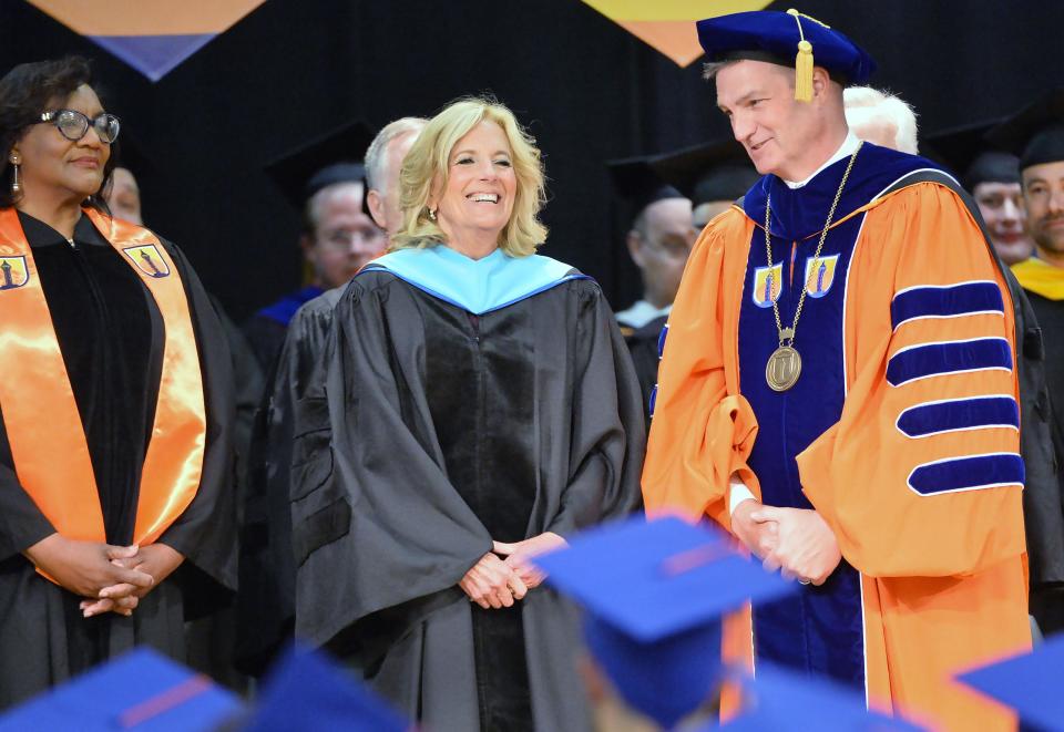 First Lady of the United States Jill Biden, center, is flanked by Erie County Community College Board of Trustees Chairperson Cheryl Rush Dix, left, and Chris Gray, Founding President of EC3, as the school's commencement ceremony begins in Millcreek Township on June 1, 2024.