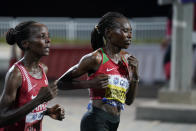 Ruth Chepngetich, of Kenya, right, leads Rose Chelimo, of Bahrain, during the women's marathon at the World Athletics Championships in Doha, Qatar, Saturday, Sept. 28, 2019. Chepngetich won the marathon. (AP Photo/Nick Didlick, Pool)