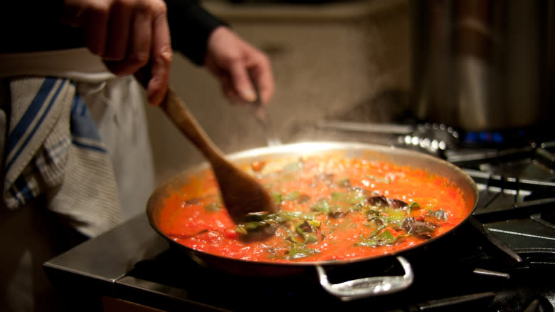 stirring spaghetti sauce