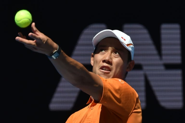 Japan's Kei Nishikori serves against Germany's Philipp Kohlschreiber during their men's singles first round match of the Australian Open, in Melbourne, on January 18, 2016