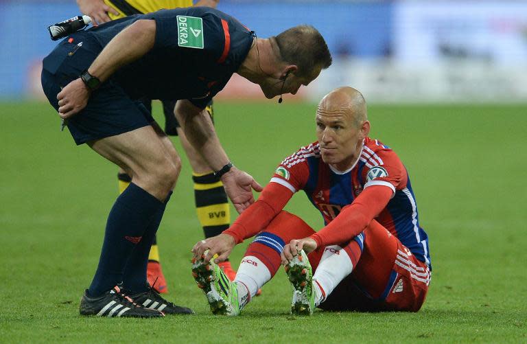 Referee Peter Gagelmann speaks to injured Bayern Munich's player Arjen Robben during their German Cup semi-final match against Borussia Dortmund, at Allianz Arena in Munich, southern Germany, on April 28, 2015