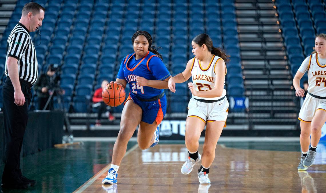 Auburn Mountainview’s Kyra Thomas pushes the ball up court alongside Lakeside defender Kayla Garmoe during the opening day of the WIAA State Basketball tournament in the Tacoma Dome in Tacoma, Washington, on Wednesday, March 1, 2023. Lakeside won the game, 47-27.