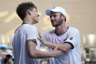 Tommy Paul, right, of the U.S. is congratulated by compatriot Ben Shelton following their quarterfinal match at the Australian Open tennis championship in Melbourne, Australia, Wednesday, Jan. 25, 2023.(AP Photo/Dita Alangkara)