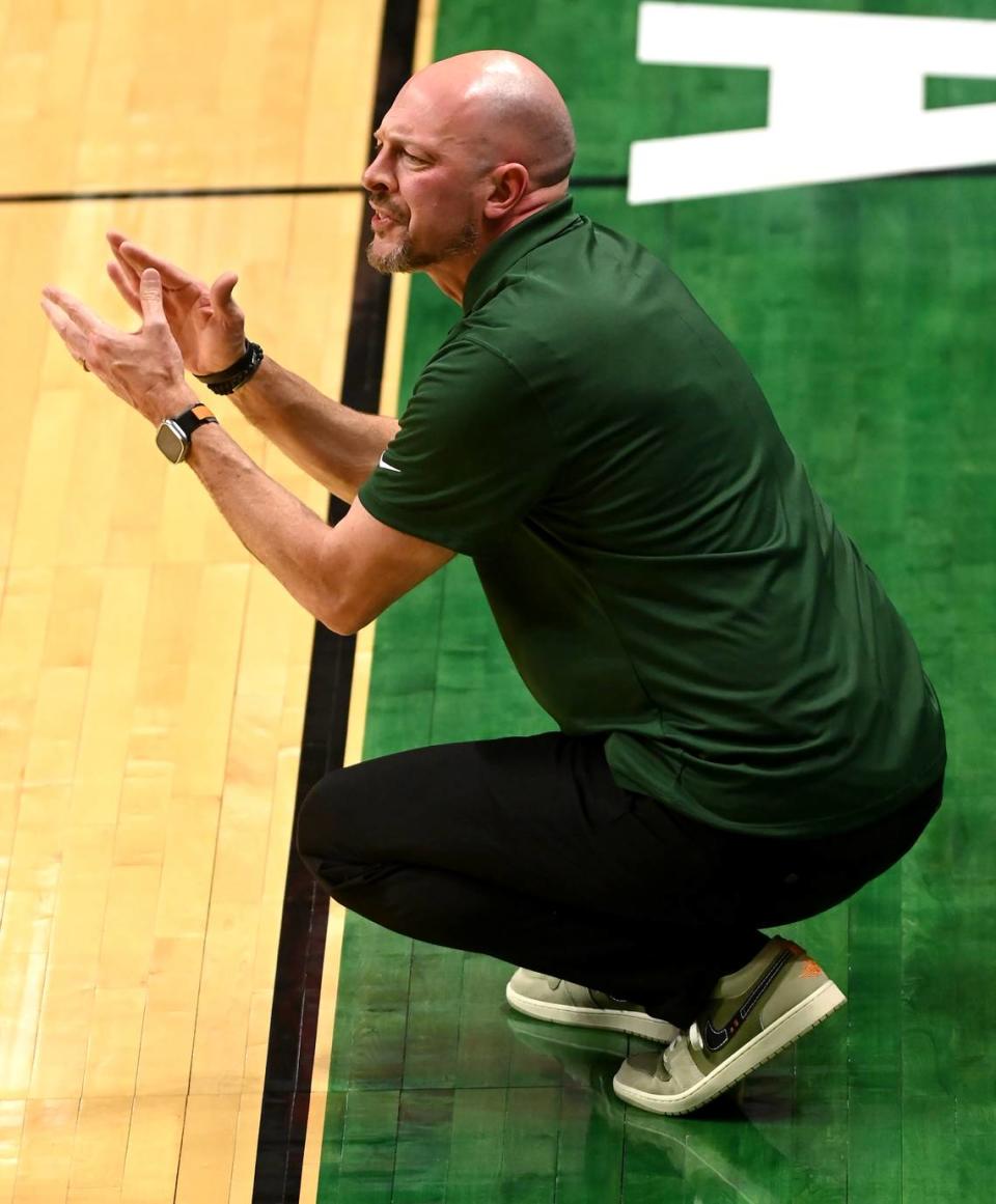 Charlotte 49ers head coach Aaron Fearne encourages his team during first half action against the Davidson Wildcats on Wednesday, November 29, 2023.