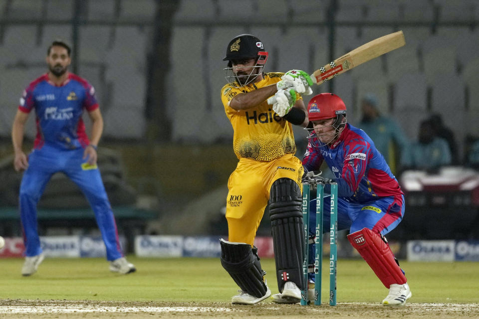 Peshawar Zalmi' Babar Azam, center, plays a shot during the Pakistan Super League T20 cricket match between Peshawar Zalmi and Karachi Kings, in Karachi, Pakistan, Monday, March 11, 2024. (AP Photo/Fareed Khan)