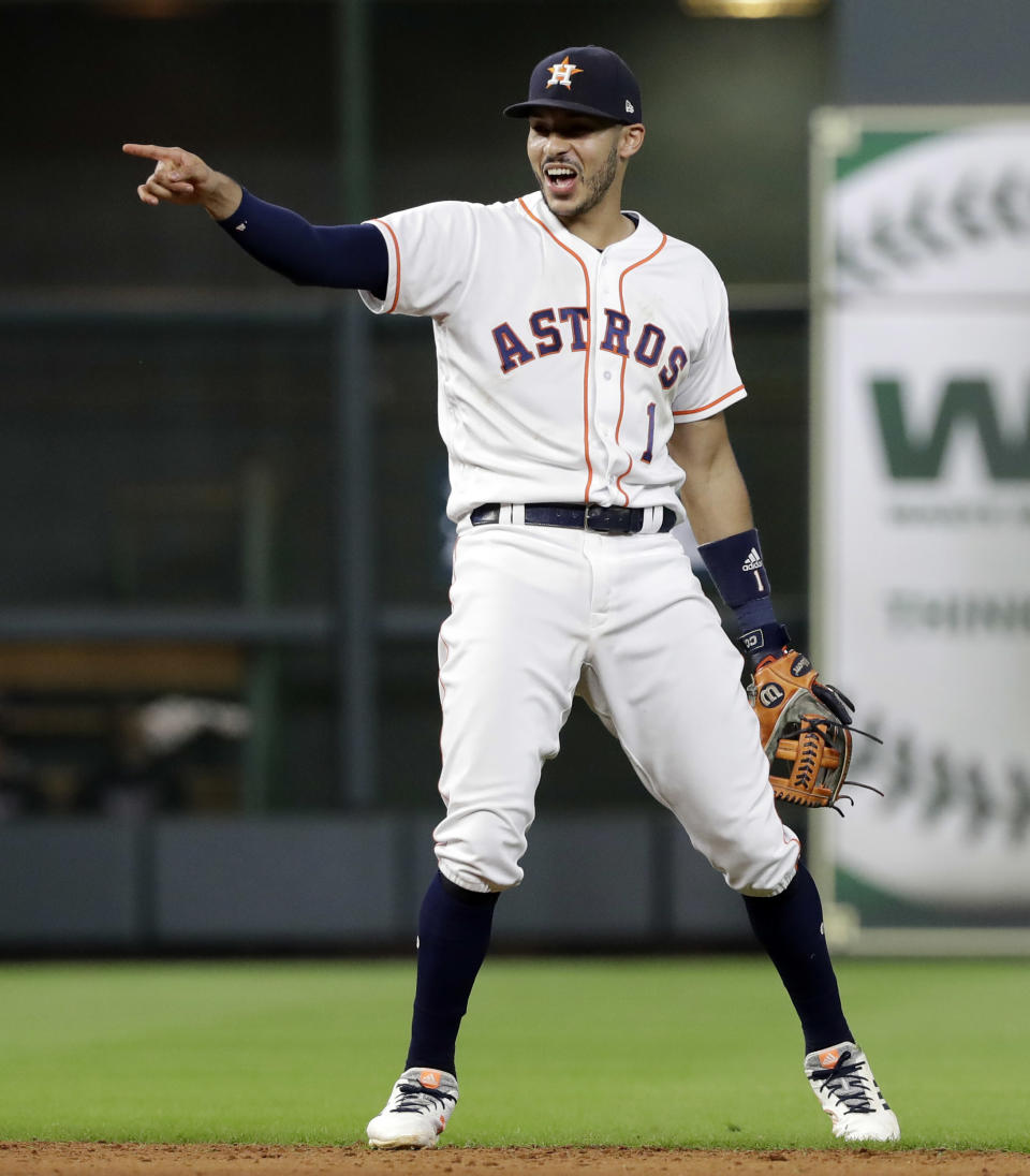 Houston Astros shortstop Carlos Correa reacts after fielding a ground ball by Colorado Rockies' Tony Wolters and throwing to first for the out during the ninth inning of a baseball game Wednesday, Aug. 15, 2018, in Houston. The Astros won 12-1. (AP Photo/David J. Phillip)